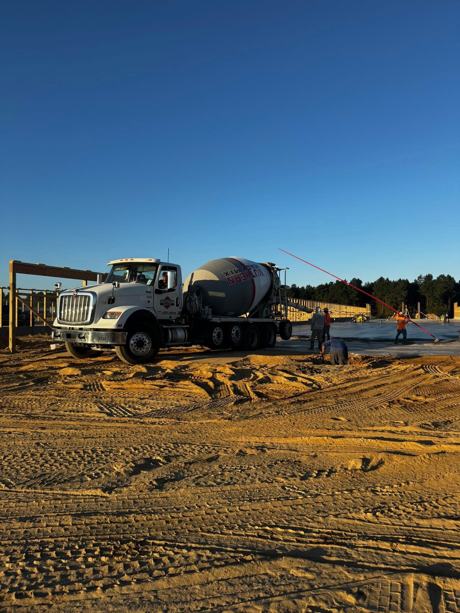 Commercial concrete pour with workers at construction site