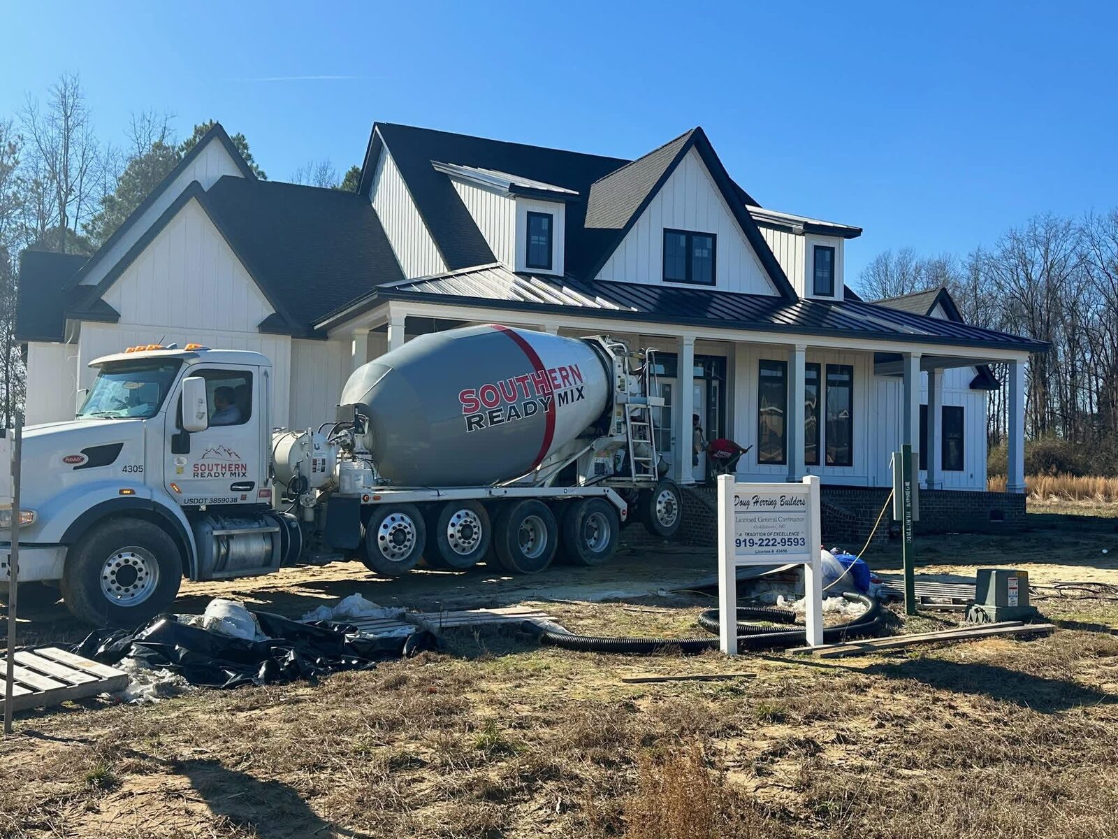SRM mixer truck delivering concrete at custom home construction site