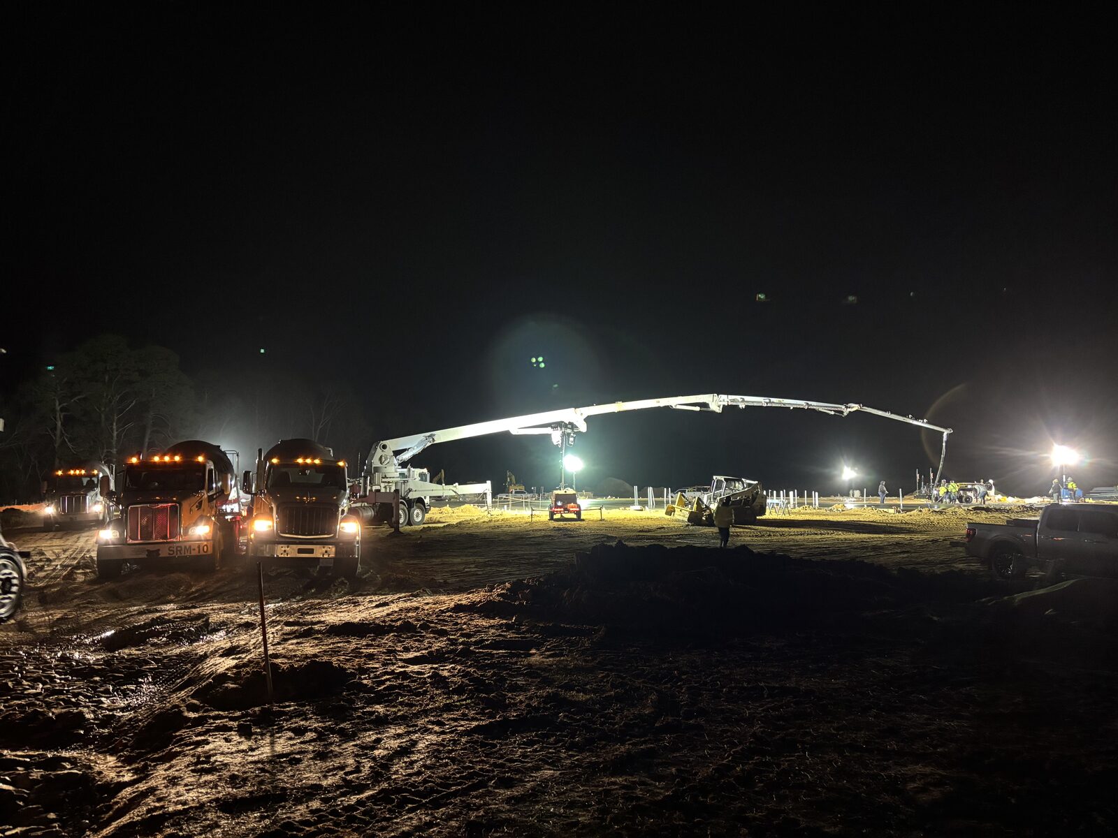 Southern Ready Mix fleet of mixer trucks lined up at the plant with silos