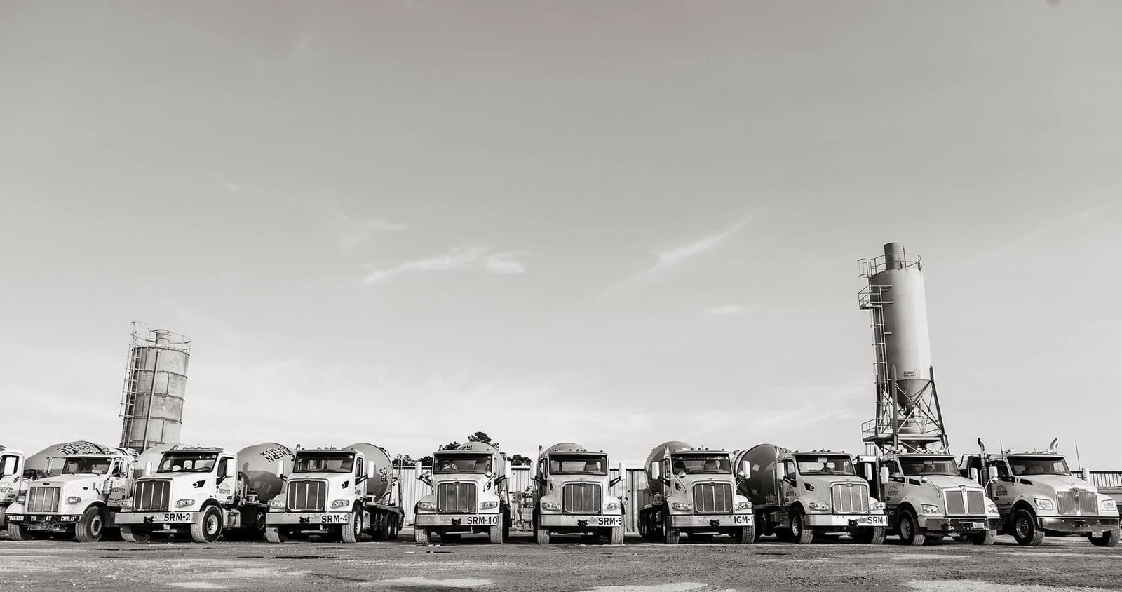 SRM mixer trucks and crew working night commercial pour under floodlights