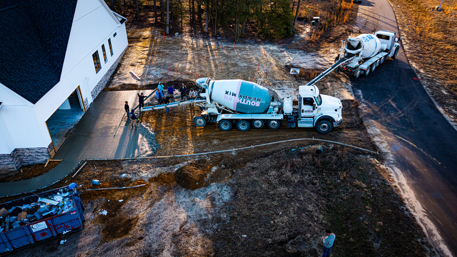 Drone shot of SRM truck approaching residential neighborhood for delivery
