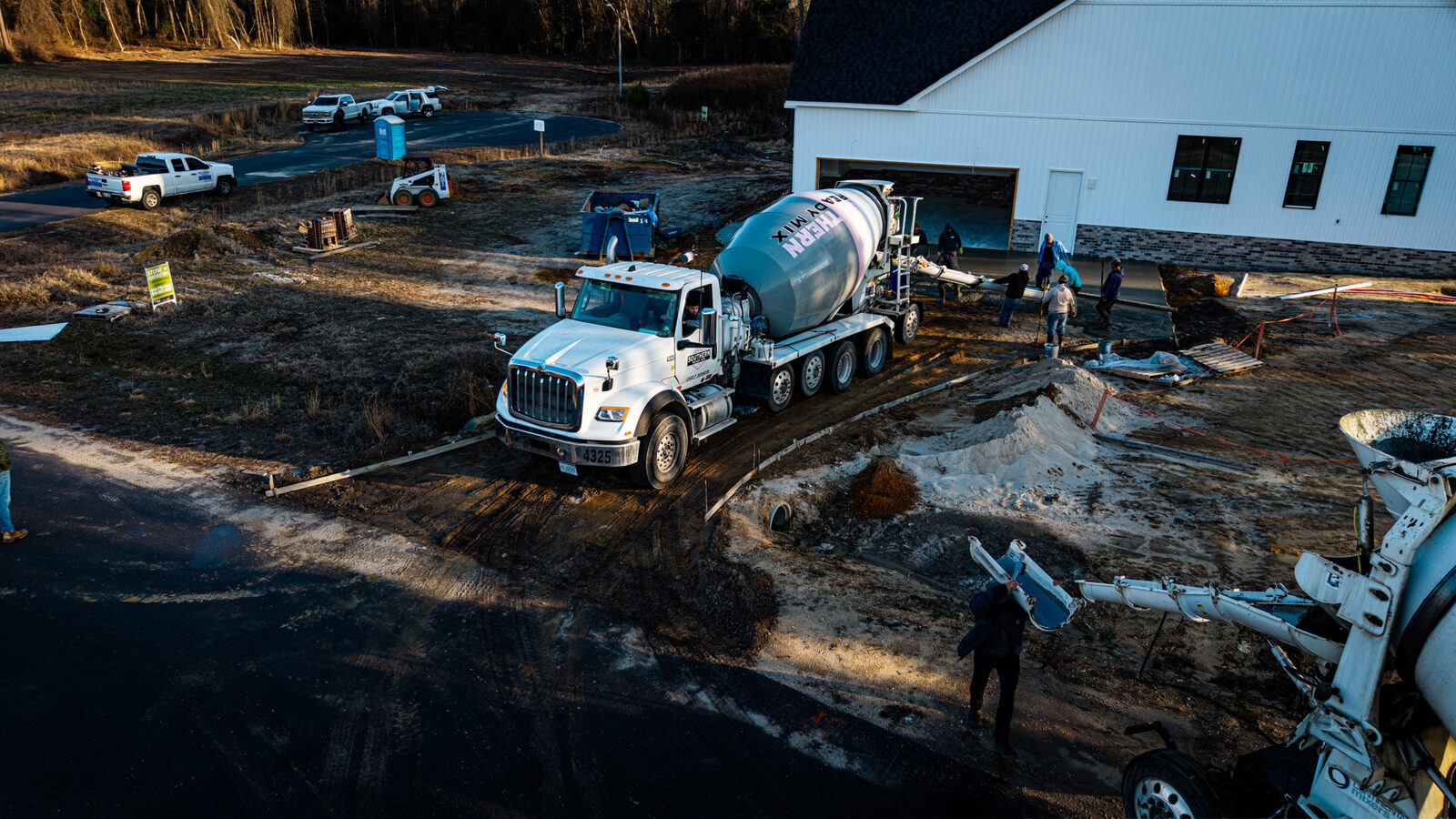 Aerial view of concrete slab pour with SRM truck and crew on site