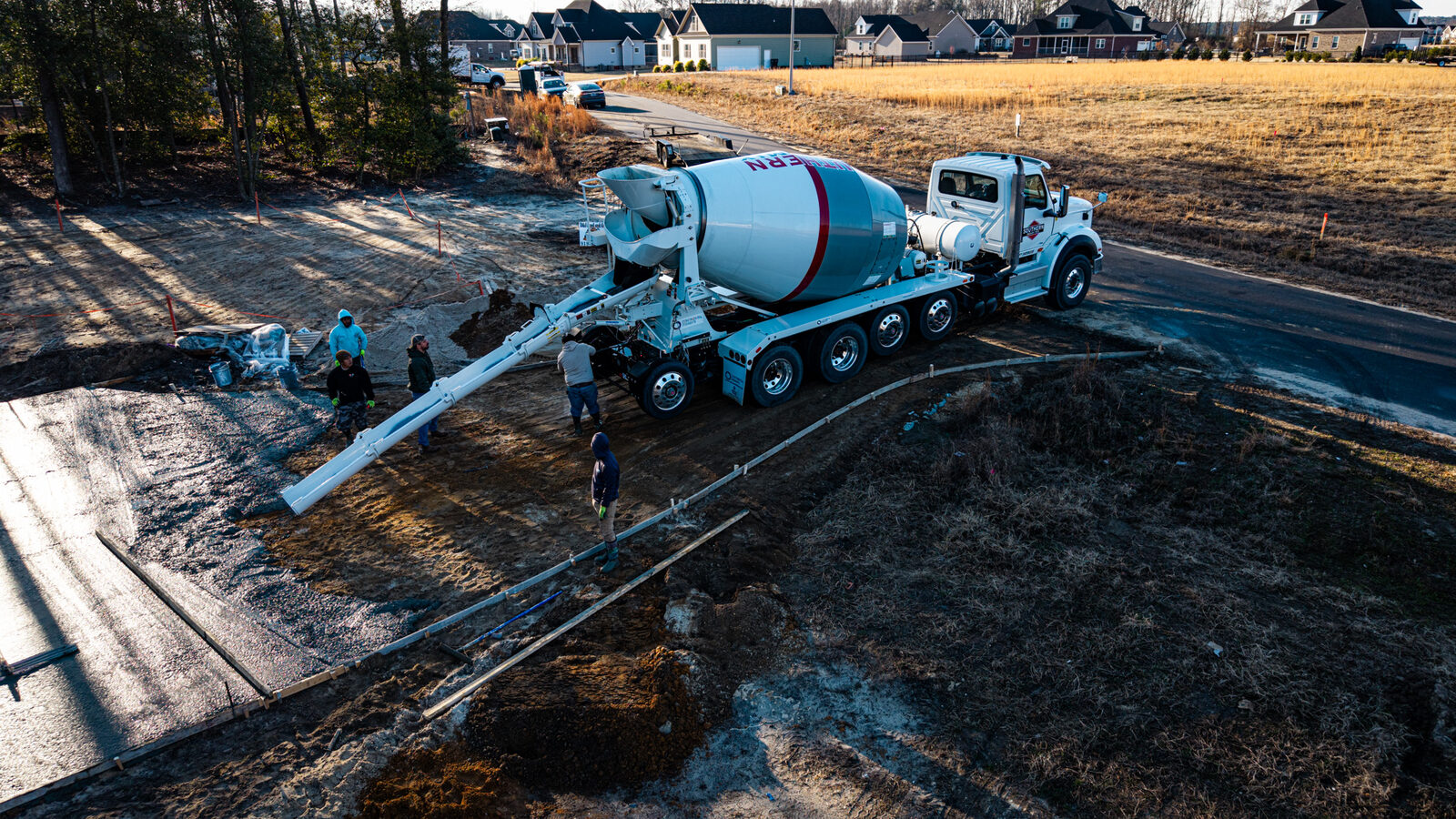 Aerial shot of residential foundation pour with SRM crew and mixer truck
