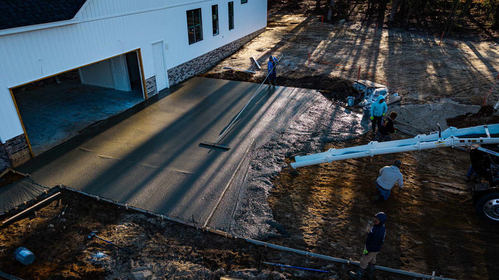 Drone view of SRM concrete delivery truck on country road at golden hour