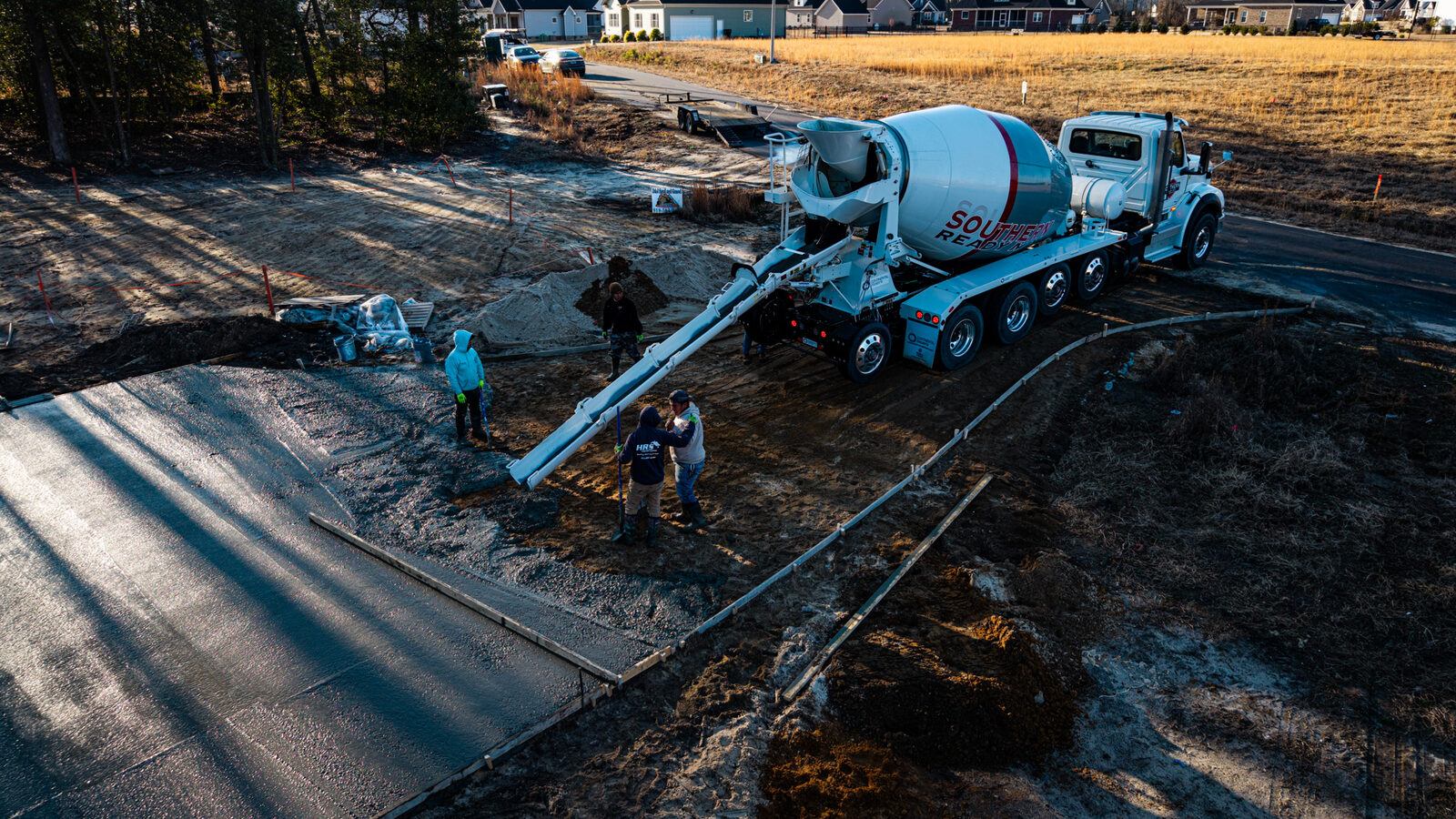 Aerial shot of residential concrete pour with pump truck and SRM mixers