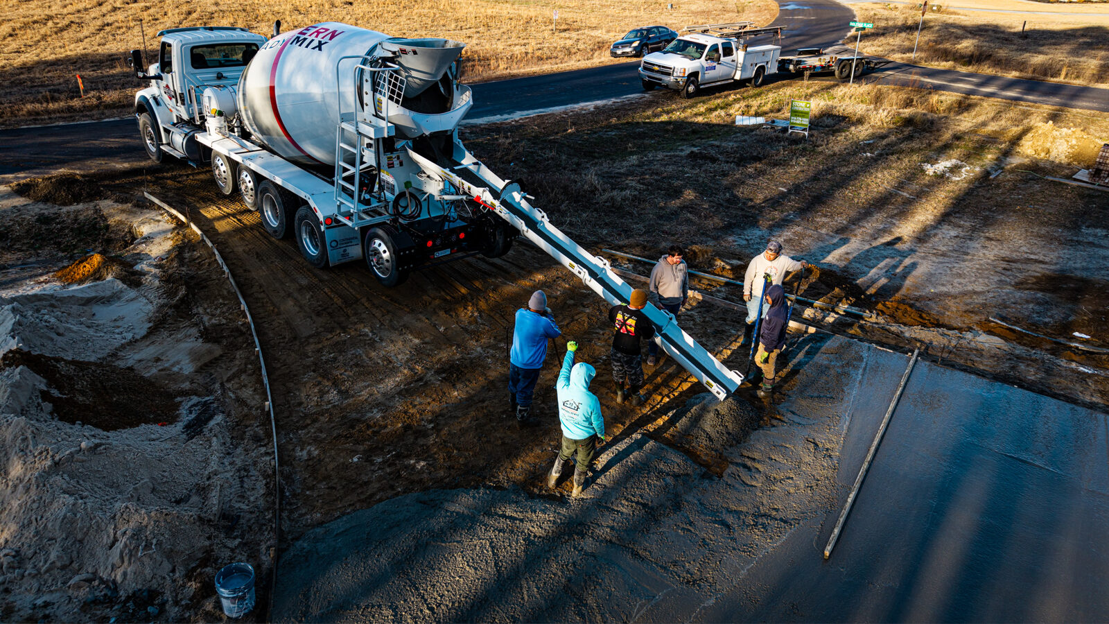 Drone view of residential slab pour with crew finishing concrete