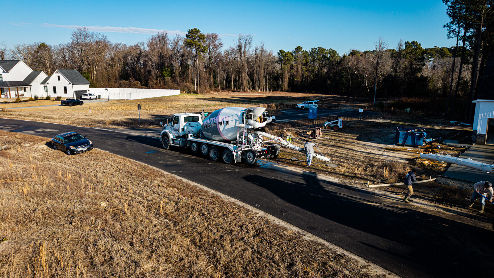 Aerial view of large residential foundation pour with SRM trucks on site