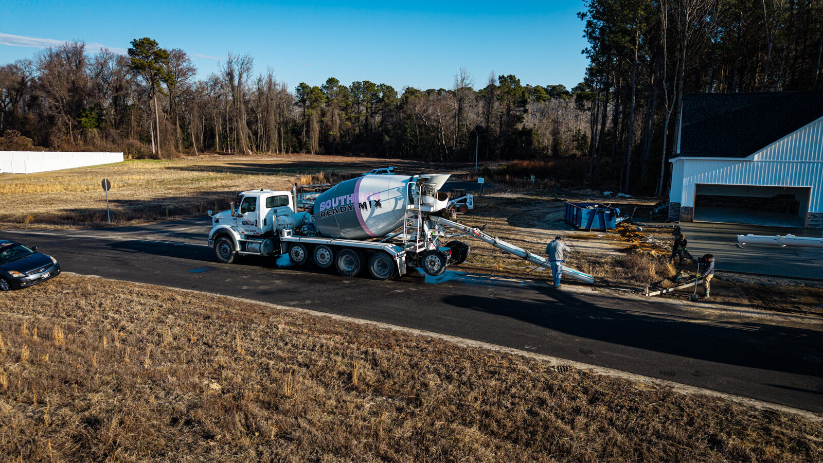 Drone view of mixer truck and pump truck working together on foundation