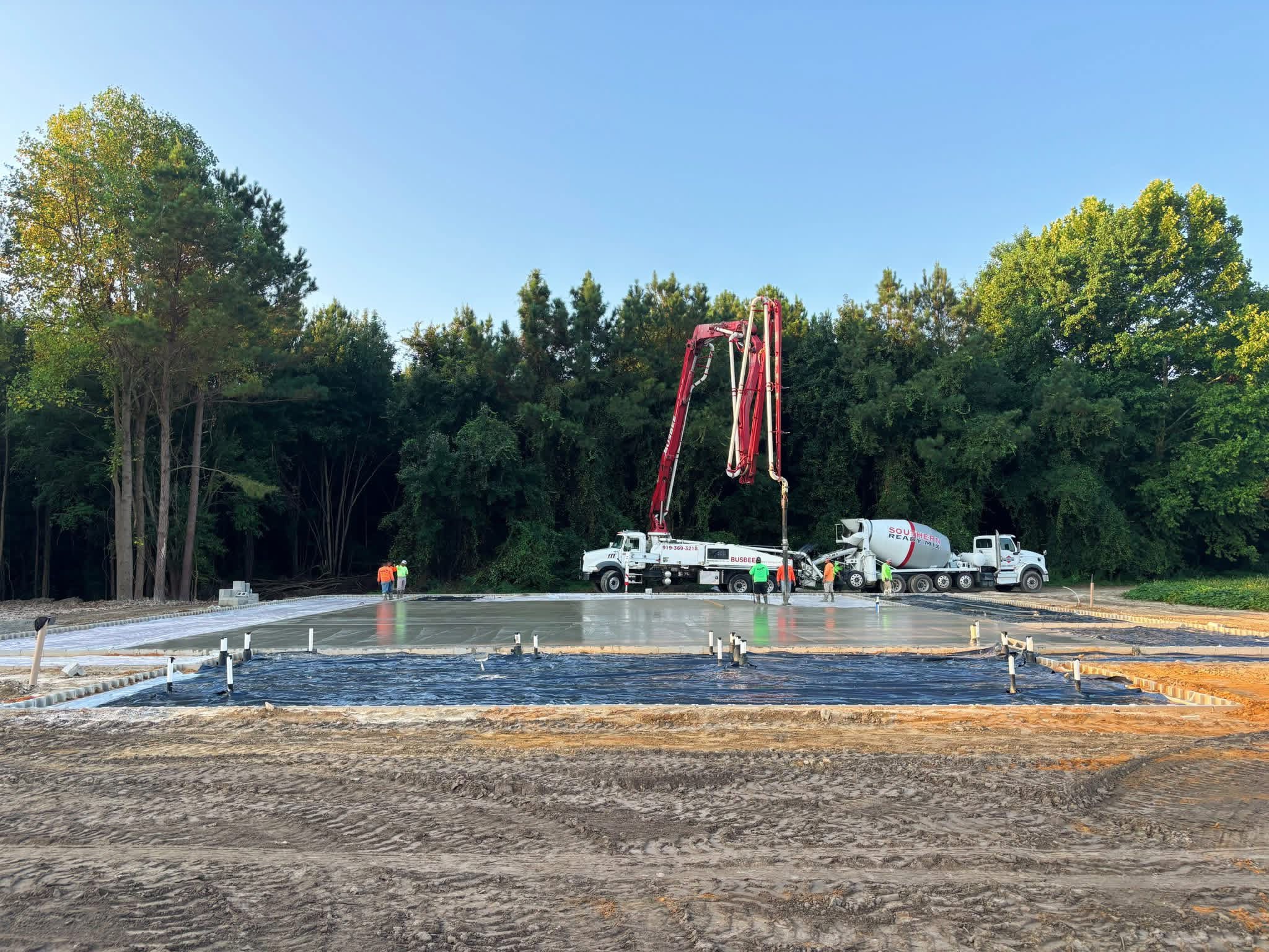 SRM pump truck and mixer on residential job site delivering concrete